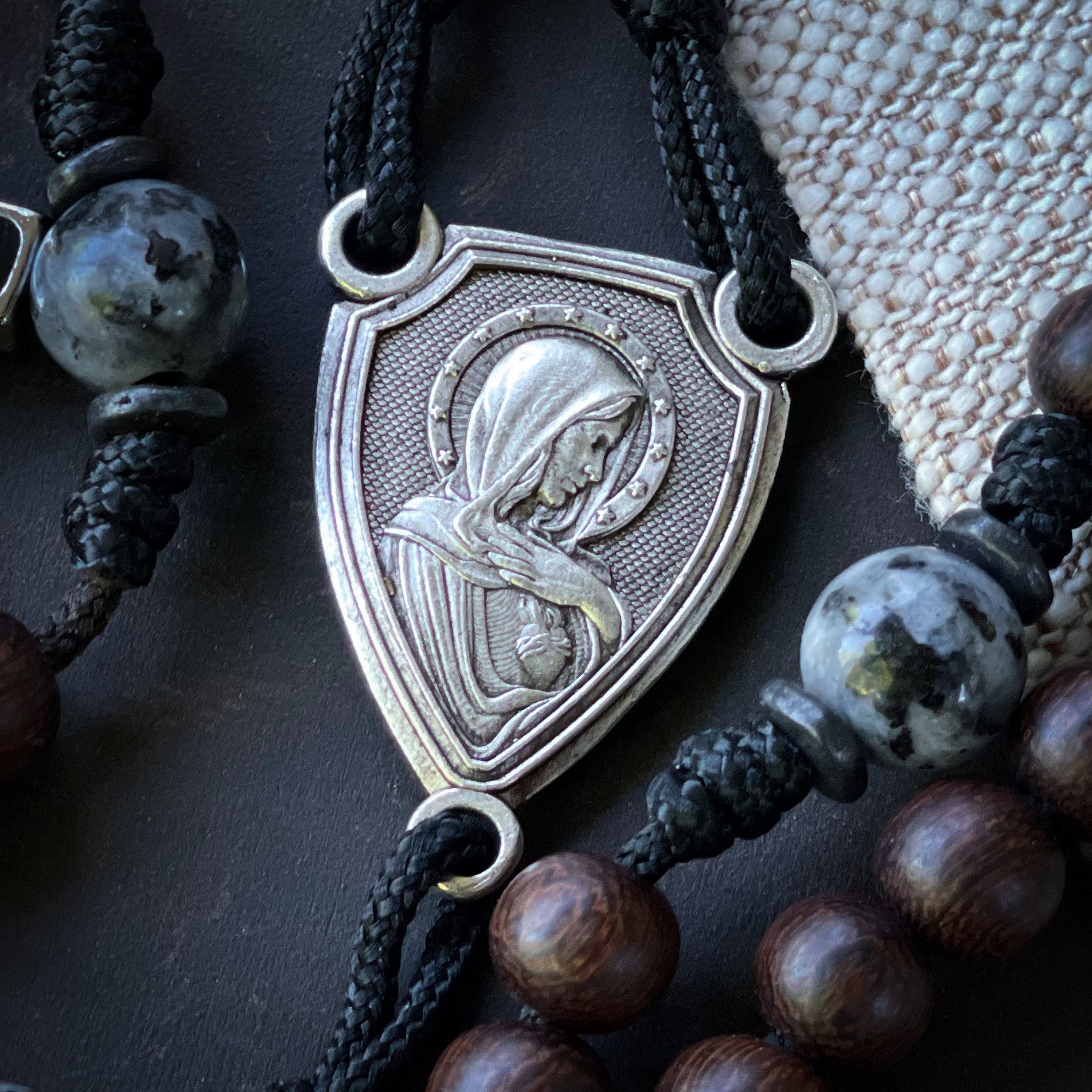 Close-up of a silver rosary centerpiece featuring the Immaculate Heart of Mary for the Solemnity of Mary, Mother of God.