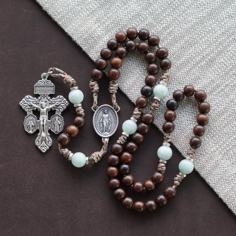 Queen of Angels Rosary — Madre de Cacao wood Hail Mary beads, Green Moonstone Our Father beads, Miraculous Medal centerpiece, and Silver 3-Way Pardon Crucifix, handcrafted by The Catholic Woodworker